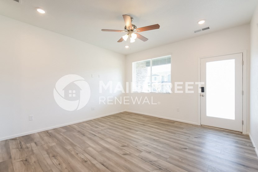 interior of a living room with a ceiling fan