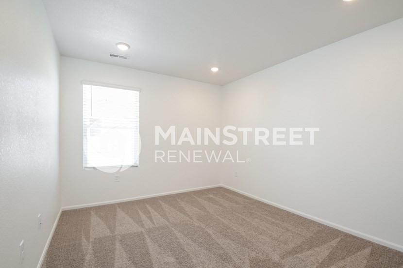 a room with a carpeted floor and a window