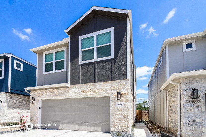 a new home with a garage door in front of it