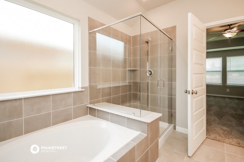 a bathroom with a large tub and a shower