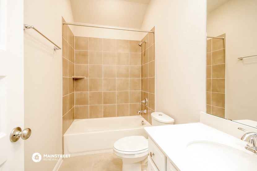 a bathroom with a tub and a sink and a toilet