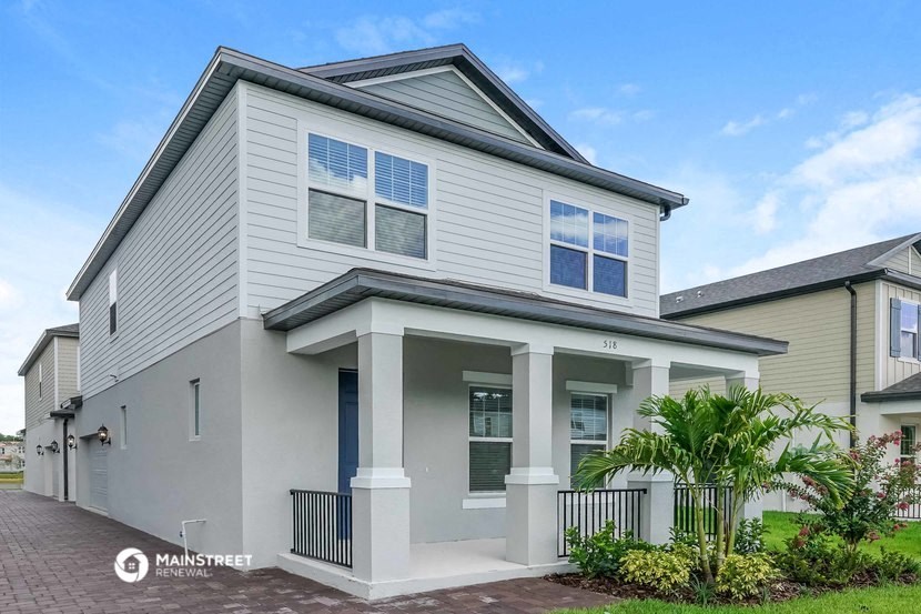 a white house with a palm tree in front of it