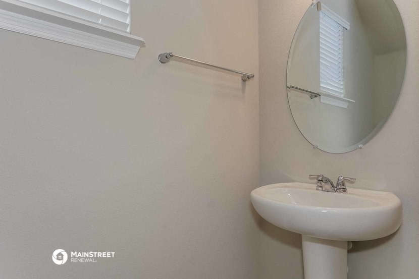 a white bathroom with a sink and a mirror