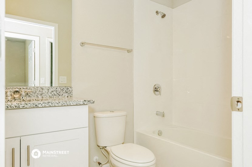 a bathroom with a shower and a toilet and a sink