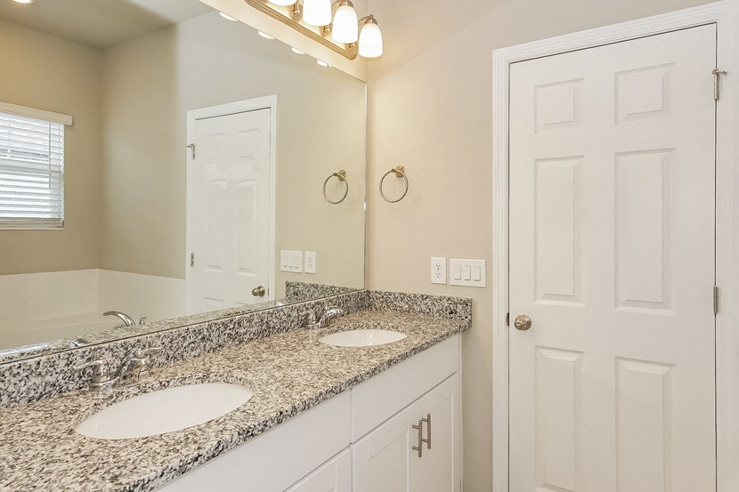 a bathroom with two sinks and a mirror