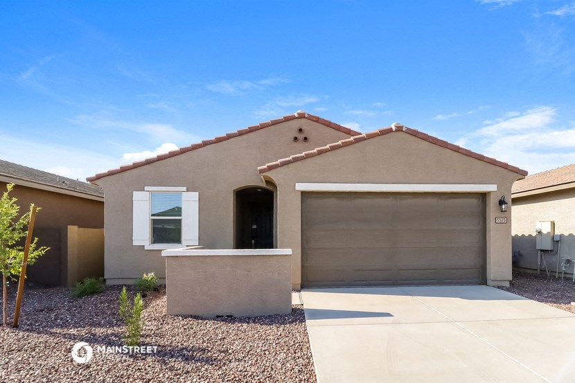 a remodeled home with a garage door in front of it