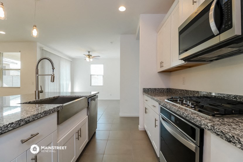 a modern kitchen with granite counter tops and stainless steel appliances
