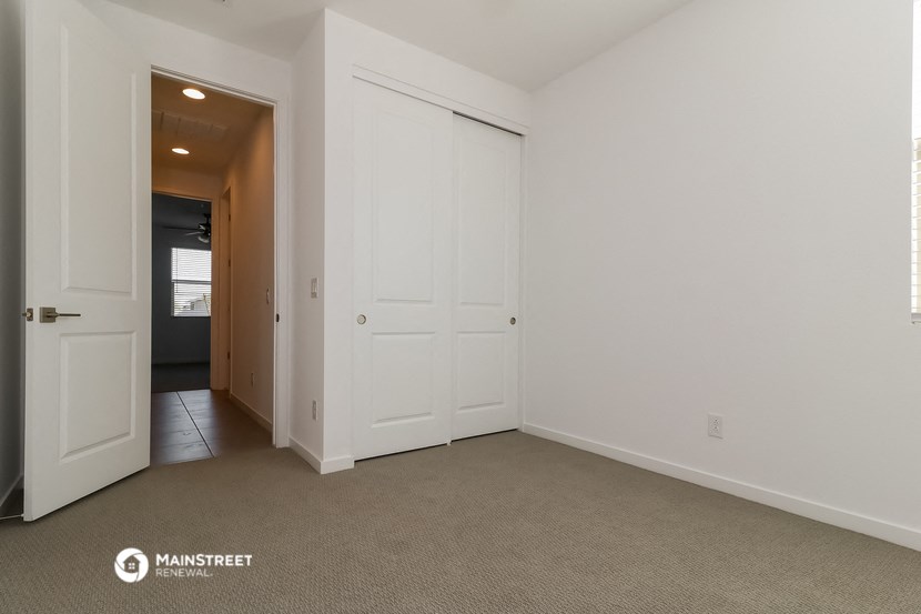 a bedroom with two closets and a door to a hallway