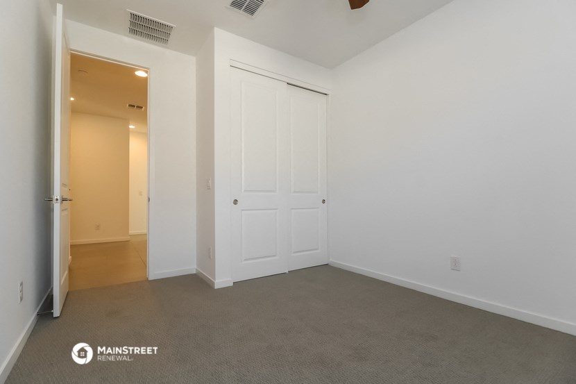 a bedroom with a closet and a door to a hallway