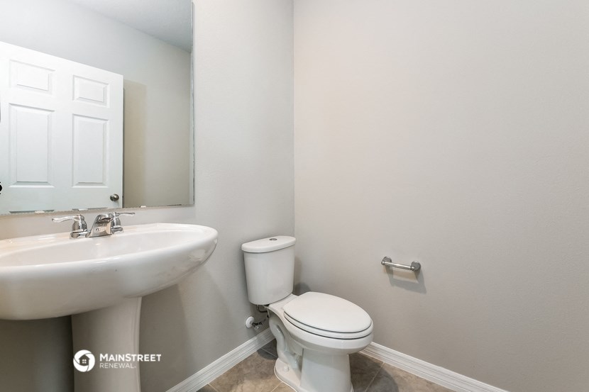a bathroom with a toilet and a sink and a mirror