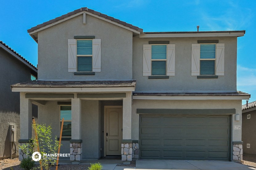 a beige house with two garage doors