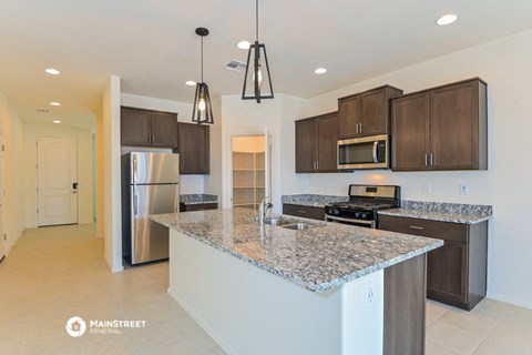 a kitchen with granite counter tops and wooden cabinets