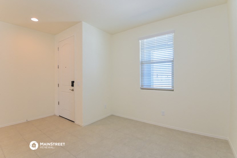 a bedroom with a door and a window and a tiled floor