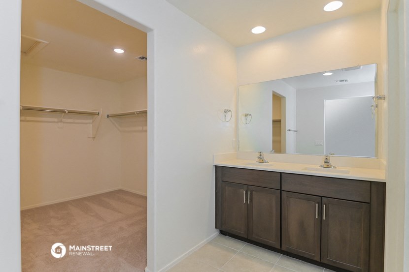 a bathroom with a sink and a mirror and a shower