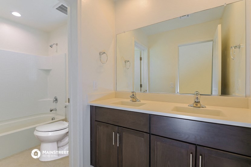 a bathroom with a sink and a toilet and a mirror