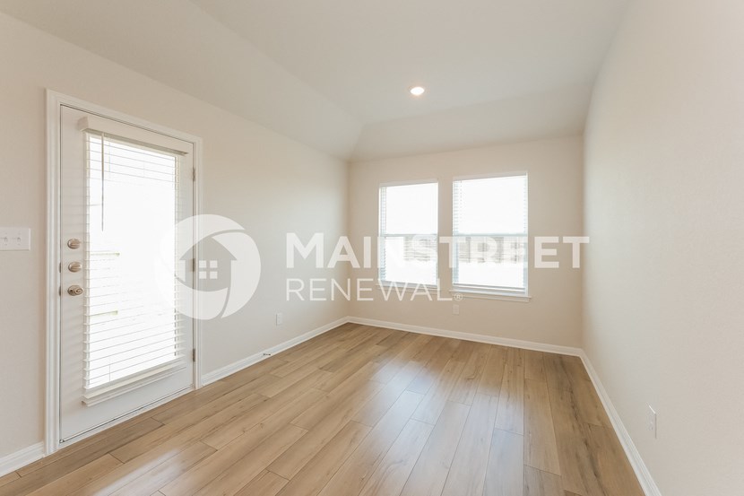 a bedroom apartment with hardwood floors and white walls