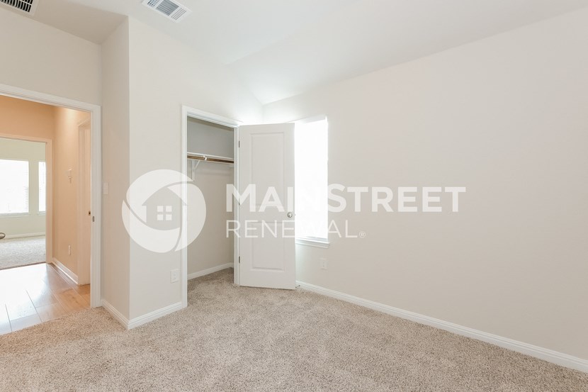 a bedroom with a closet and a door to a closet