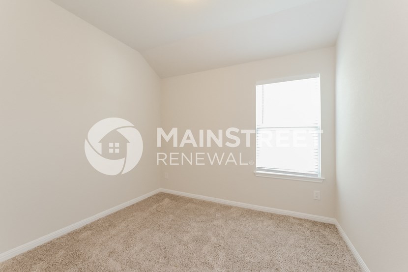 furnished bedroom with carpeted flooring and a window