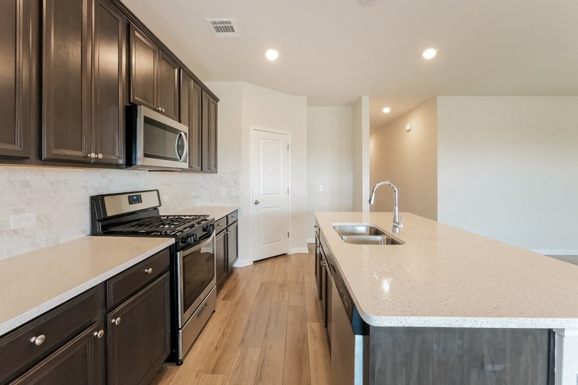 a kitchen with a large counter top and a sink