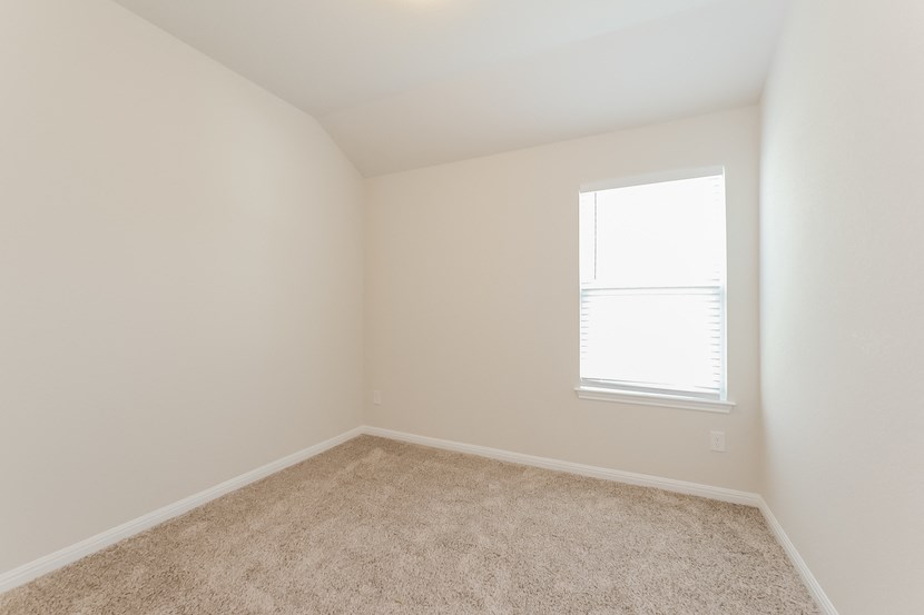 an empty room with carpet and a window