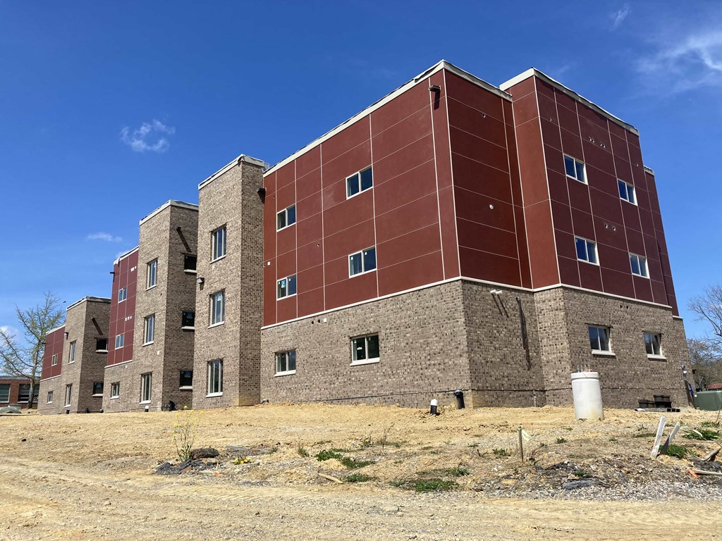 a large brick building with a blue sky in the background