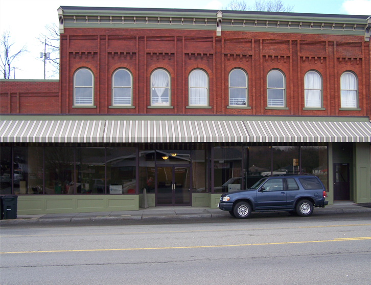 a car parked in front of a brick building