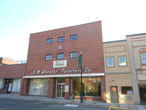 a building with a sign on the side of it on a street