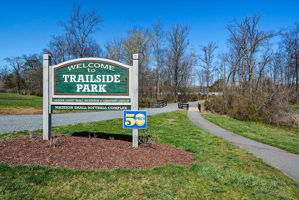 a welcome to triborough park sign in the grass