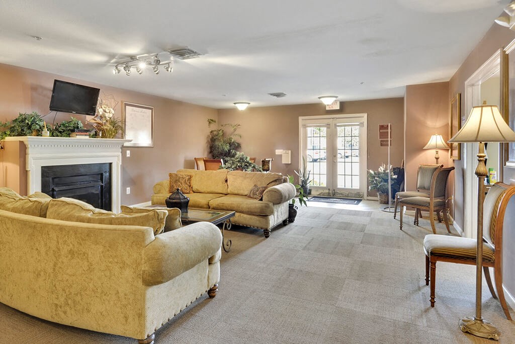 a large living room with couches and a fireplace