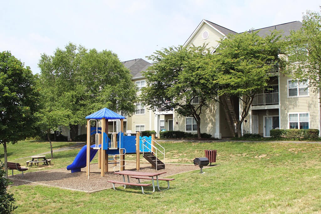 a playground in the yard of a apartment complex