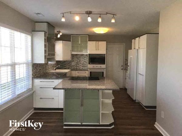 a kitchen with white cabinets and a counter top