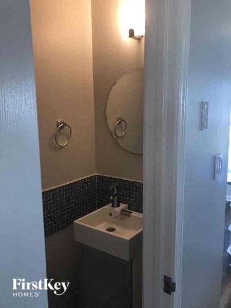 a small bathroom with a sink and a mirror