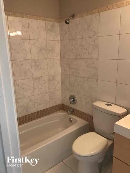 a bathroom with a toilet and a bath tub