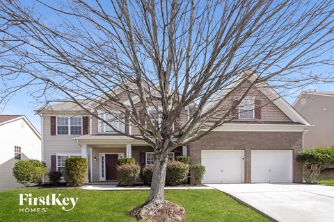 A house with a tree in front of it.