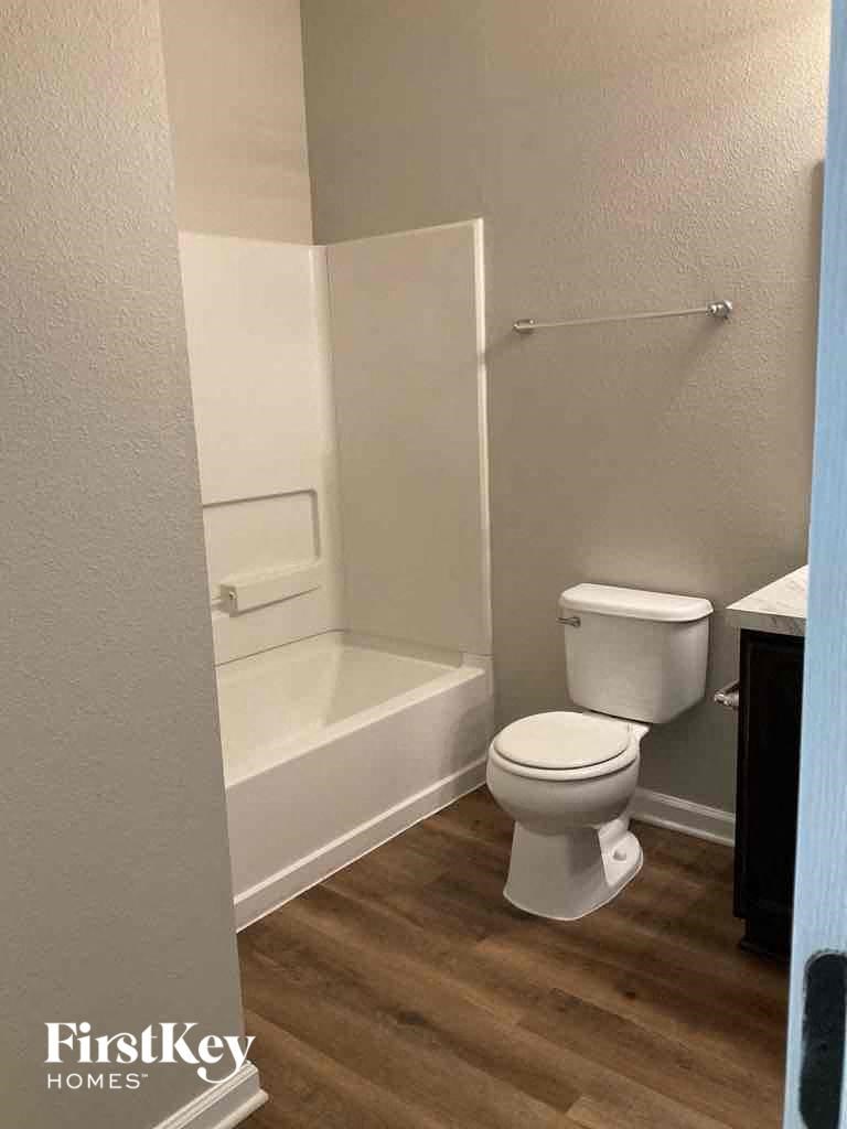a bathroom with a toilet and a bath tub