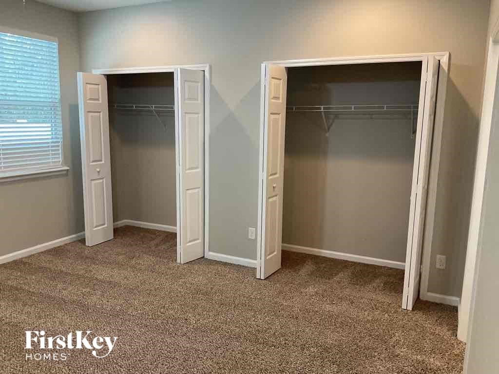 a bedroom with two closets and two doors