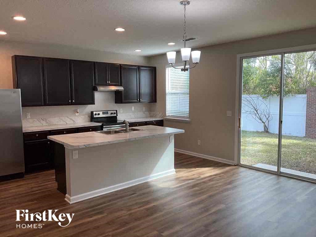 an empty kitchen with an island in the middle of it