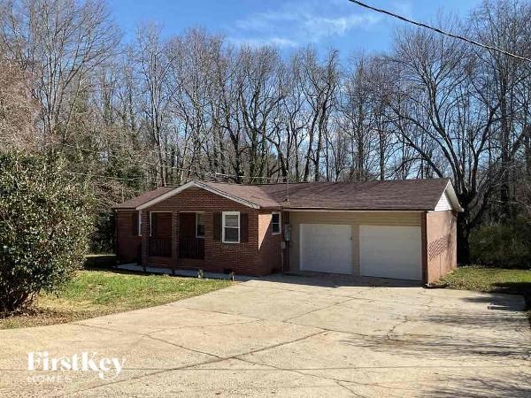 A brick house with a garage is for sale.