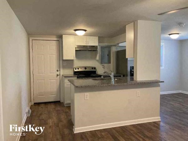 A kitchen with a white door and a counter.