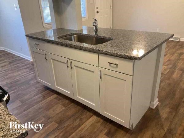 A kitchen with a granite countertop and a sink.