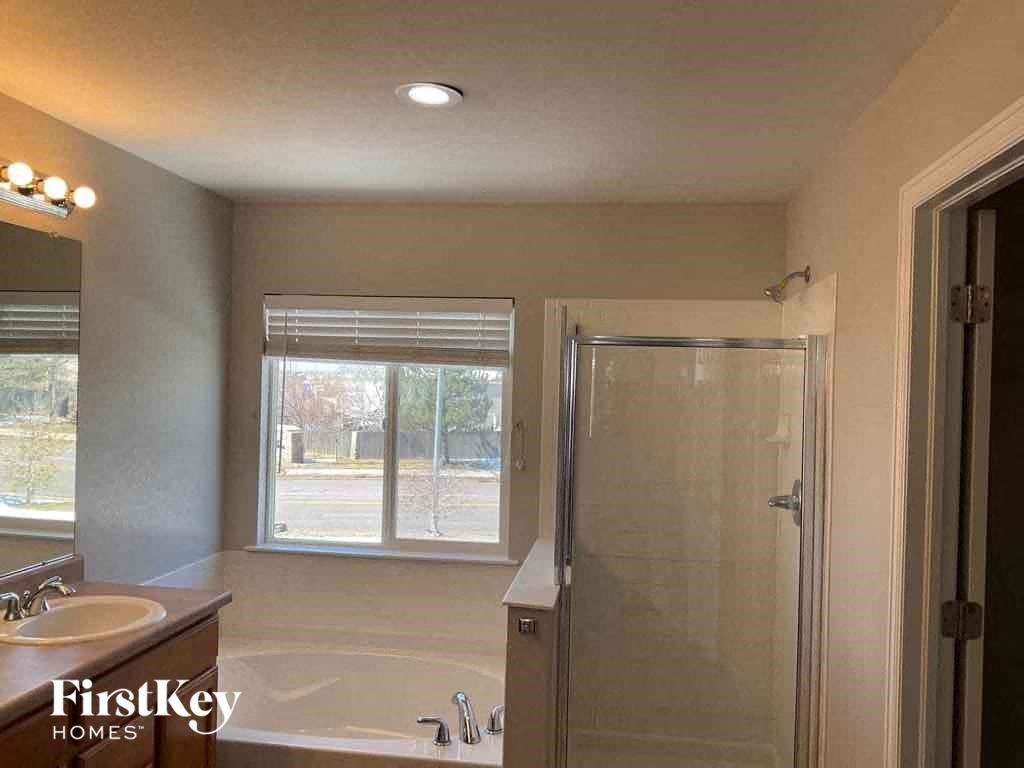 a bathroom with a shower and a sink and a mirror