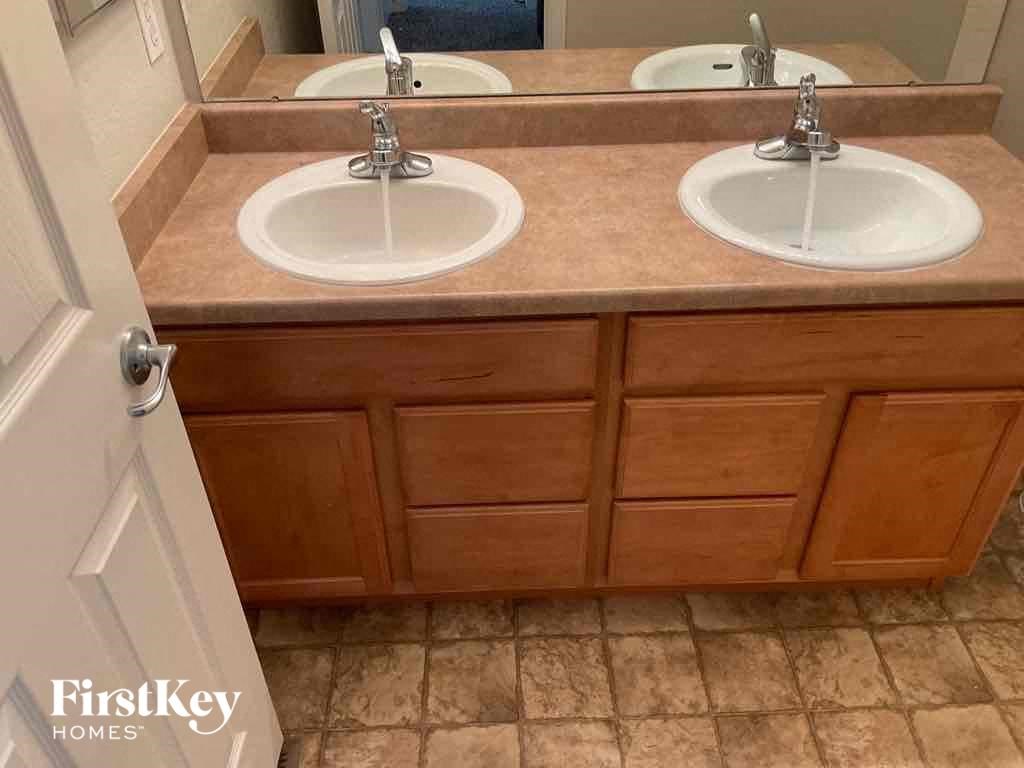 a bathroom with two sinks and a mirror