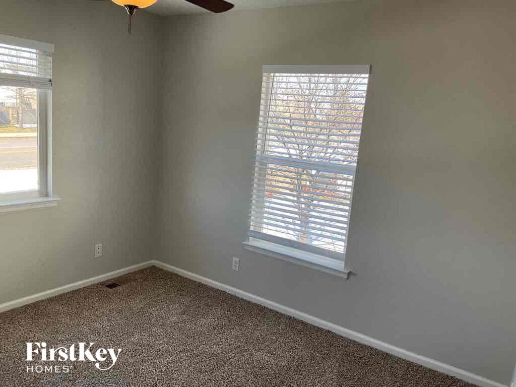 a room with a window and a carpet