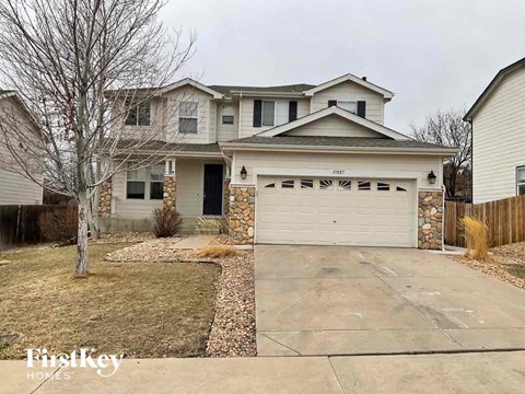a house with a white garage door in front of a driveway