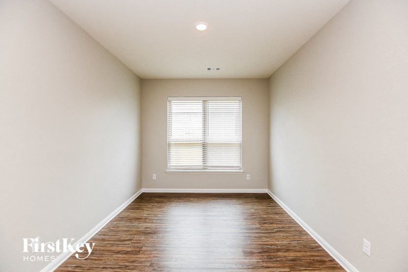 a empty room with white walls and a window