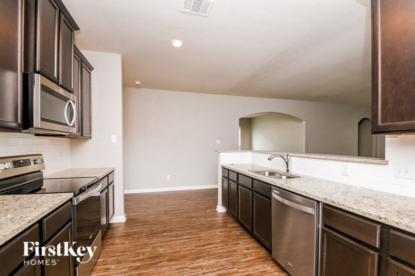a kitchen with stainless steel appliances and marble counter tops