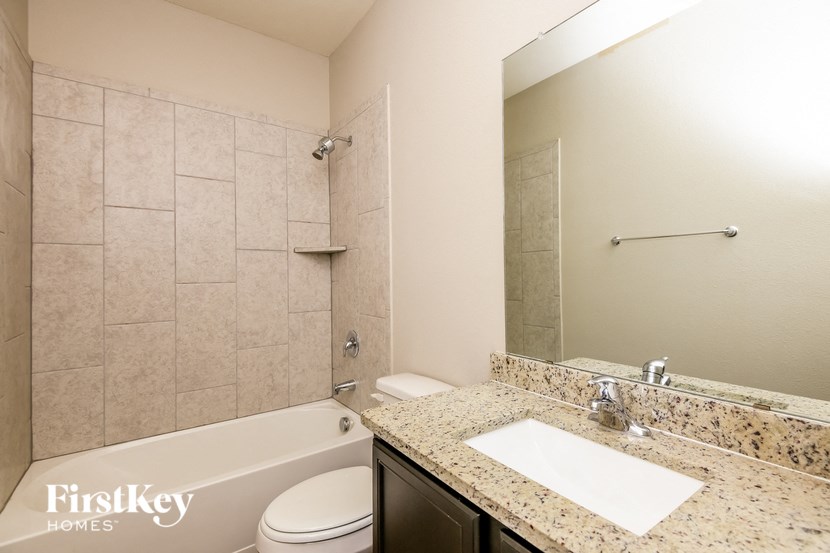 a bathroom with a sink toilet and a bath tub