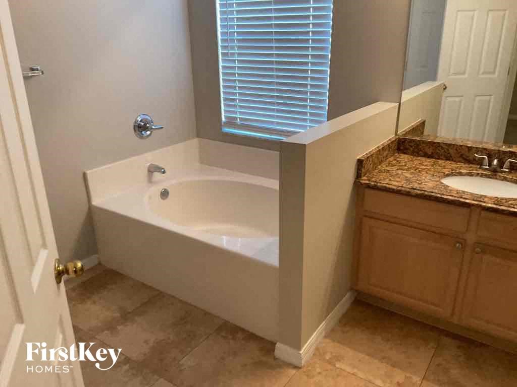 a small bathroom with a tub and a sink