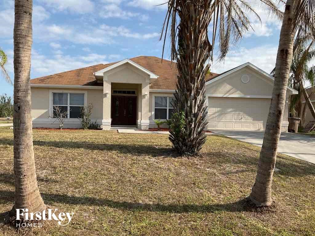 a house with palm trees in front of it