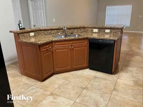 a kitchen with a granite counter top and a dishwasher
